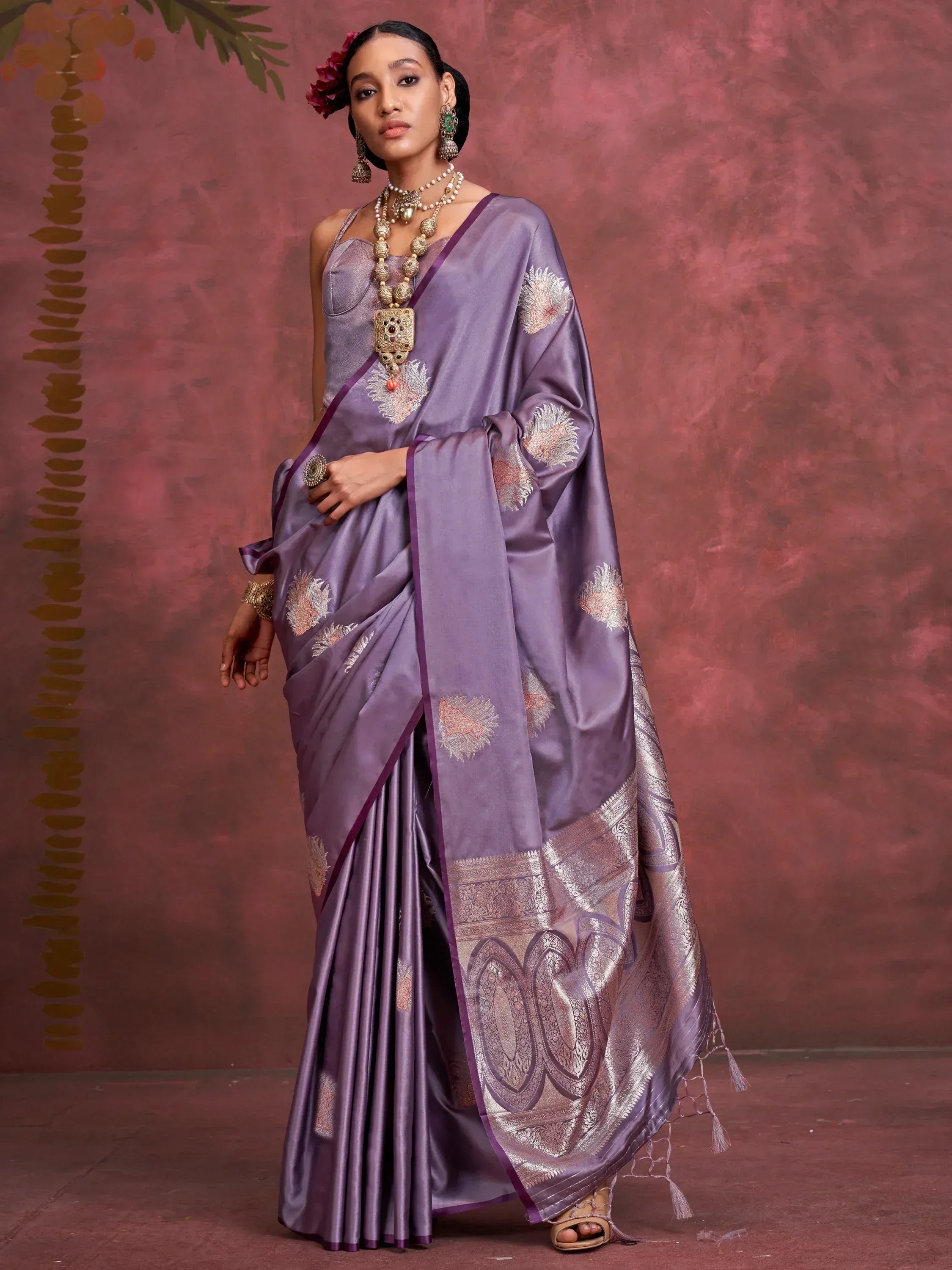 Elegant purple silk saree with floral embroidery and zari border, paired with designer jewelry for Indian ethnic wear.