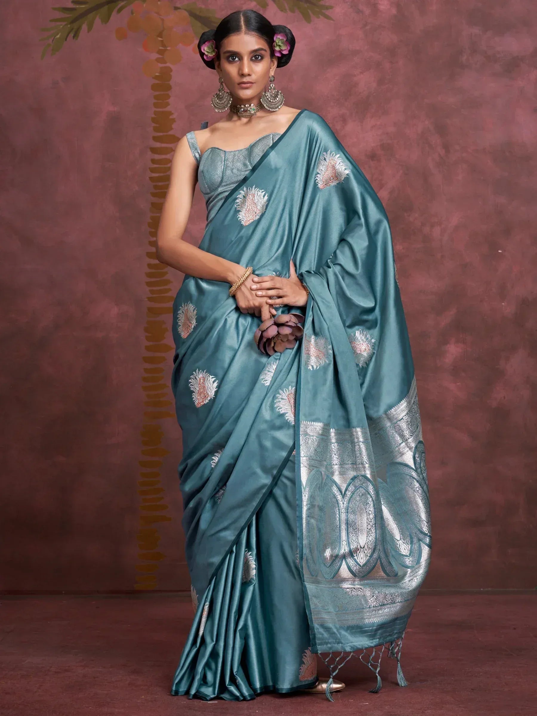 Teal silk saree with floral embroidery and silver border, paired with designer blouse for Indian ethnic wear