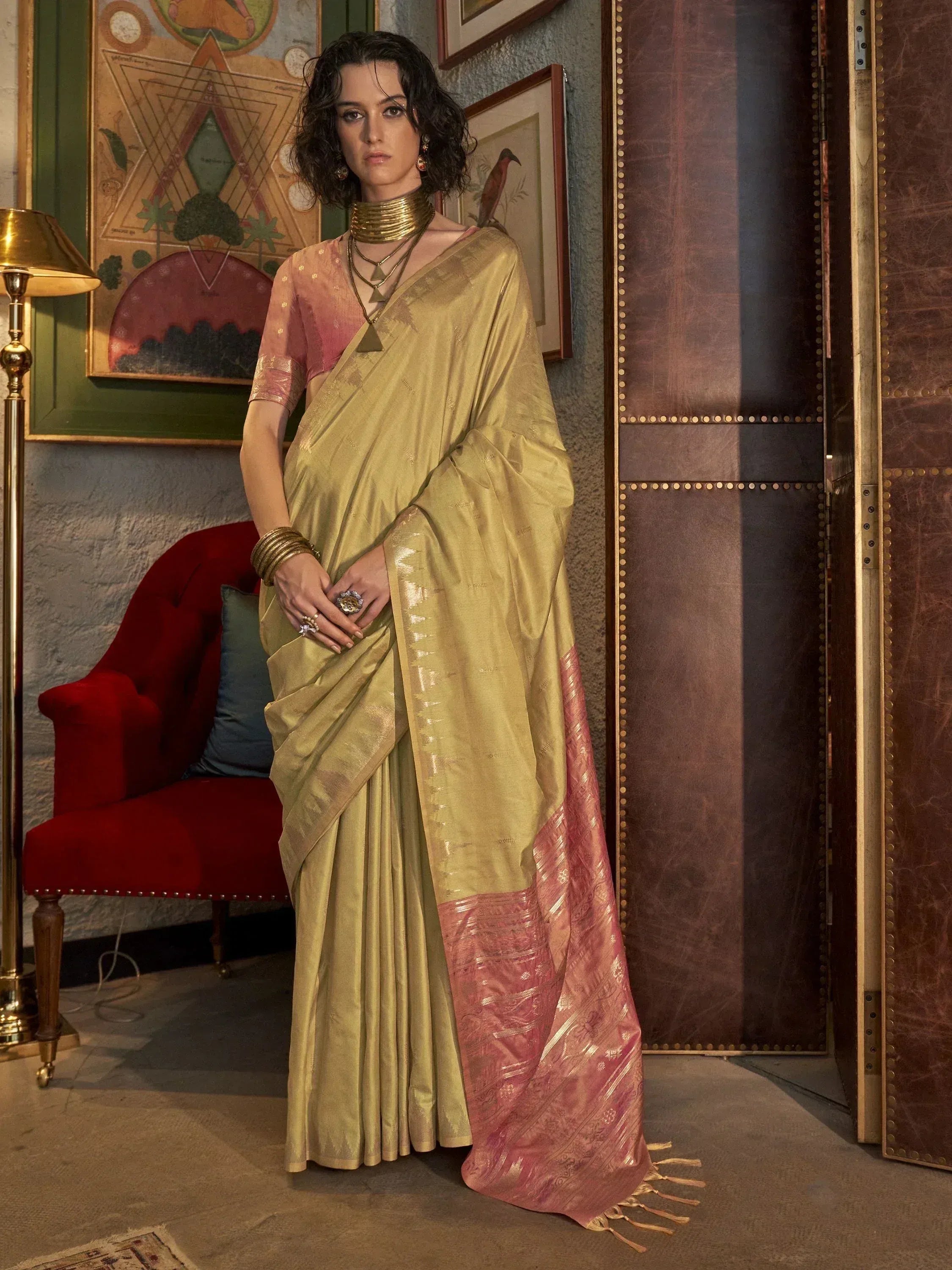 Elegant gold and pink saree with intricate weave, paired with designer blouse and gold jewelry for ethnic wear