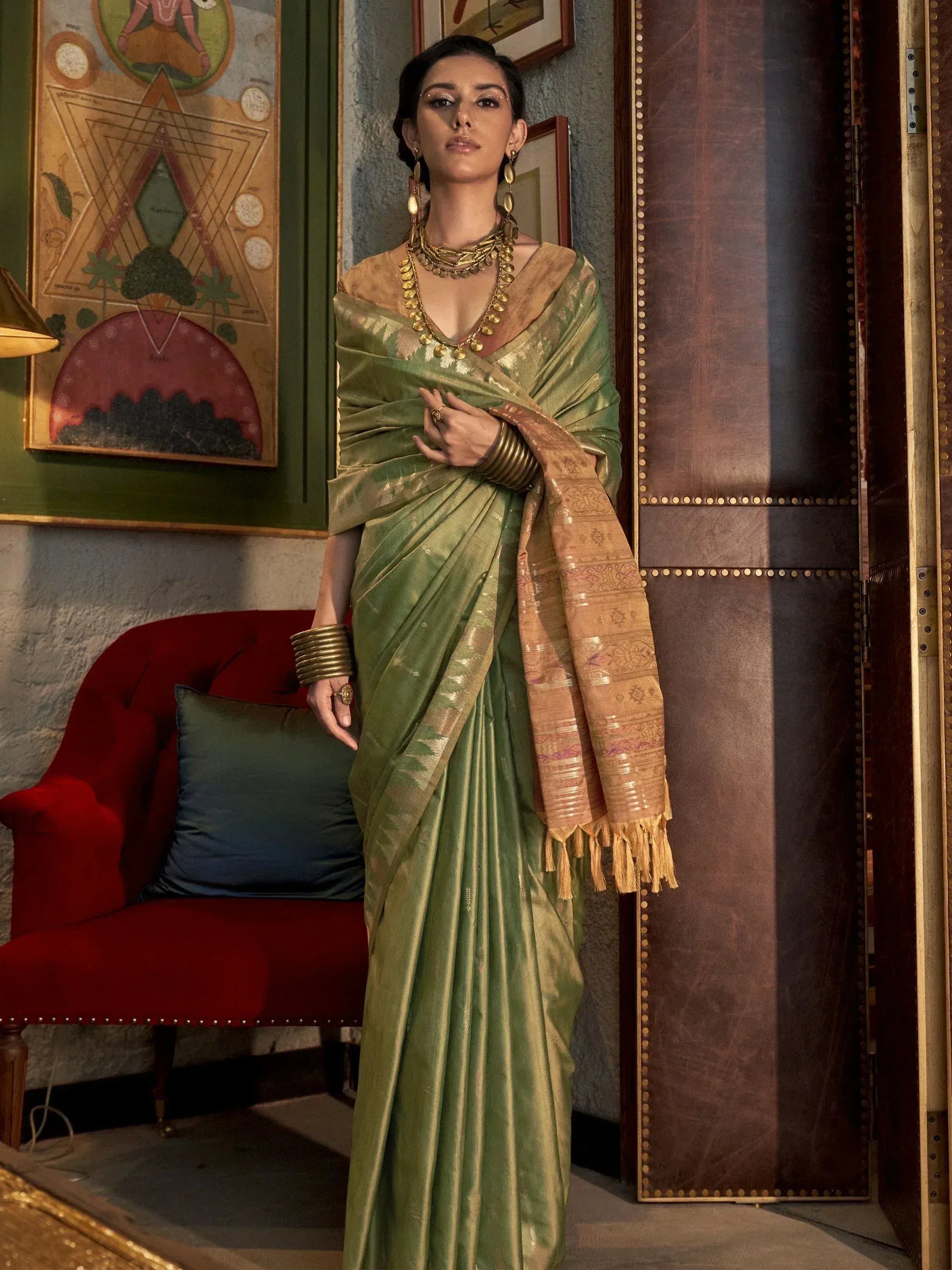 Elegant woman in olive green designer saree with gold border, traditional Indian ethnic wear