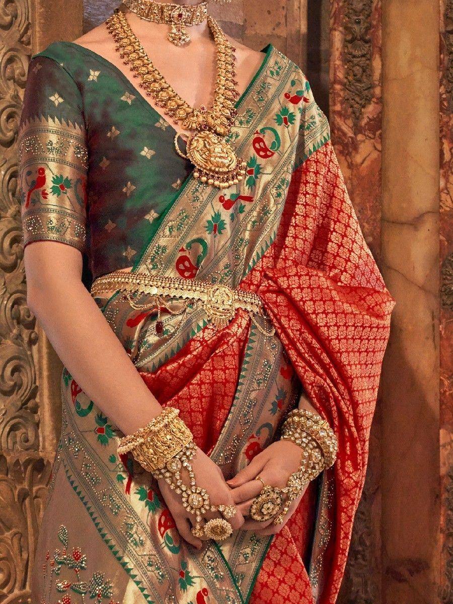 Elegant Indian saree with green blouse, red gold border, and heavy traditional jewelry for festive occasions