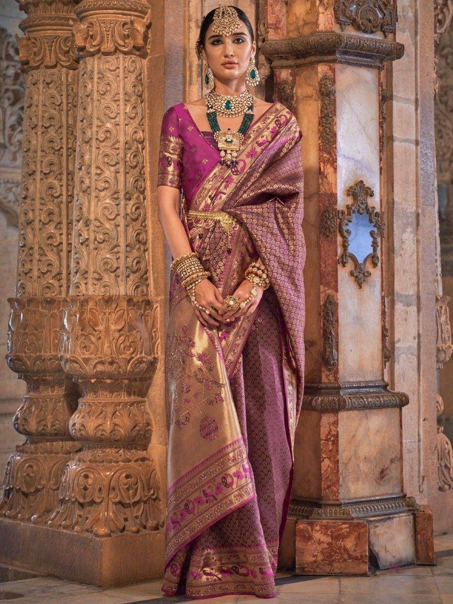 Elegant purple and gold designer saree with intricate embroidery, paired with traditional Indian jewelry and styled for festive occasions.