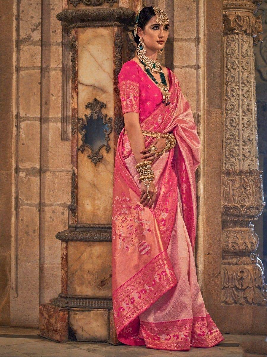Woman in pink designer saree with gold embroidery, traditional Indian ethnic wear, ornate jewelry, palace setting