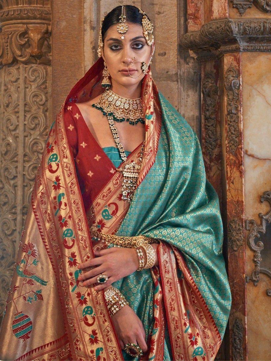 Teal and red designer saree with gold embroidery, traditional Indian bridal wear, heavy jewelry