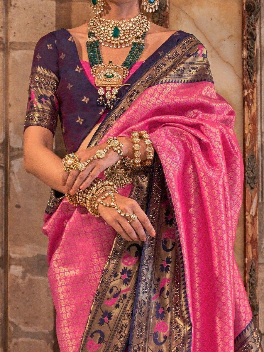 Pink and navy designer saree with gold embroidery, paired with heavy traditional jewelry for Indian ethnic wear