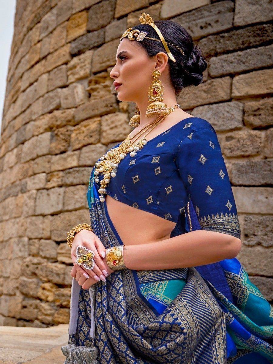 Blue designer saree with gold embroidery, traditional Indian ethnic wear, paired with temple jewelry