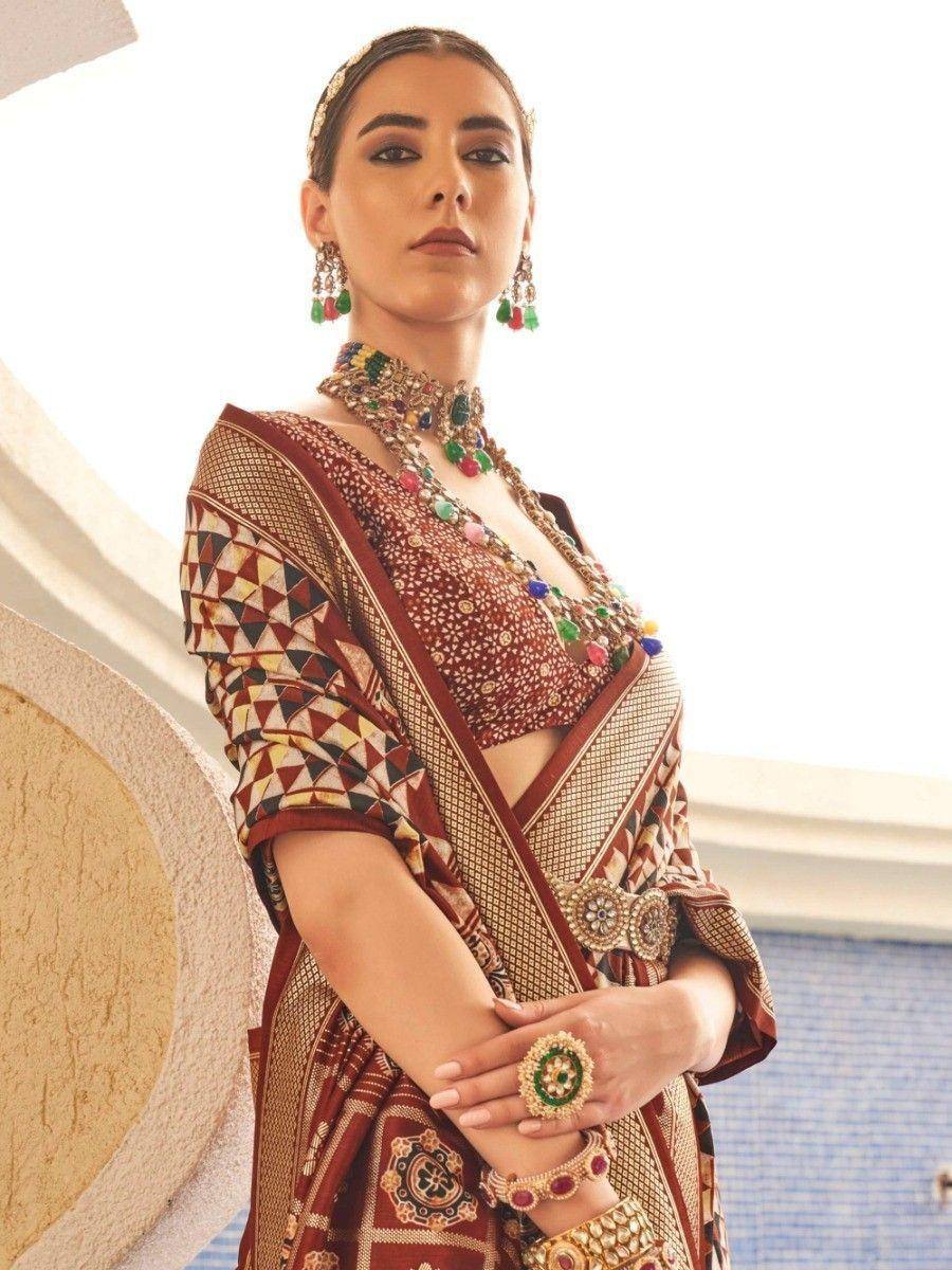 Woman in designer ethnic saree with intricate embroidery and traditional jewelry, perfect for Indian weddings