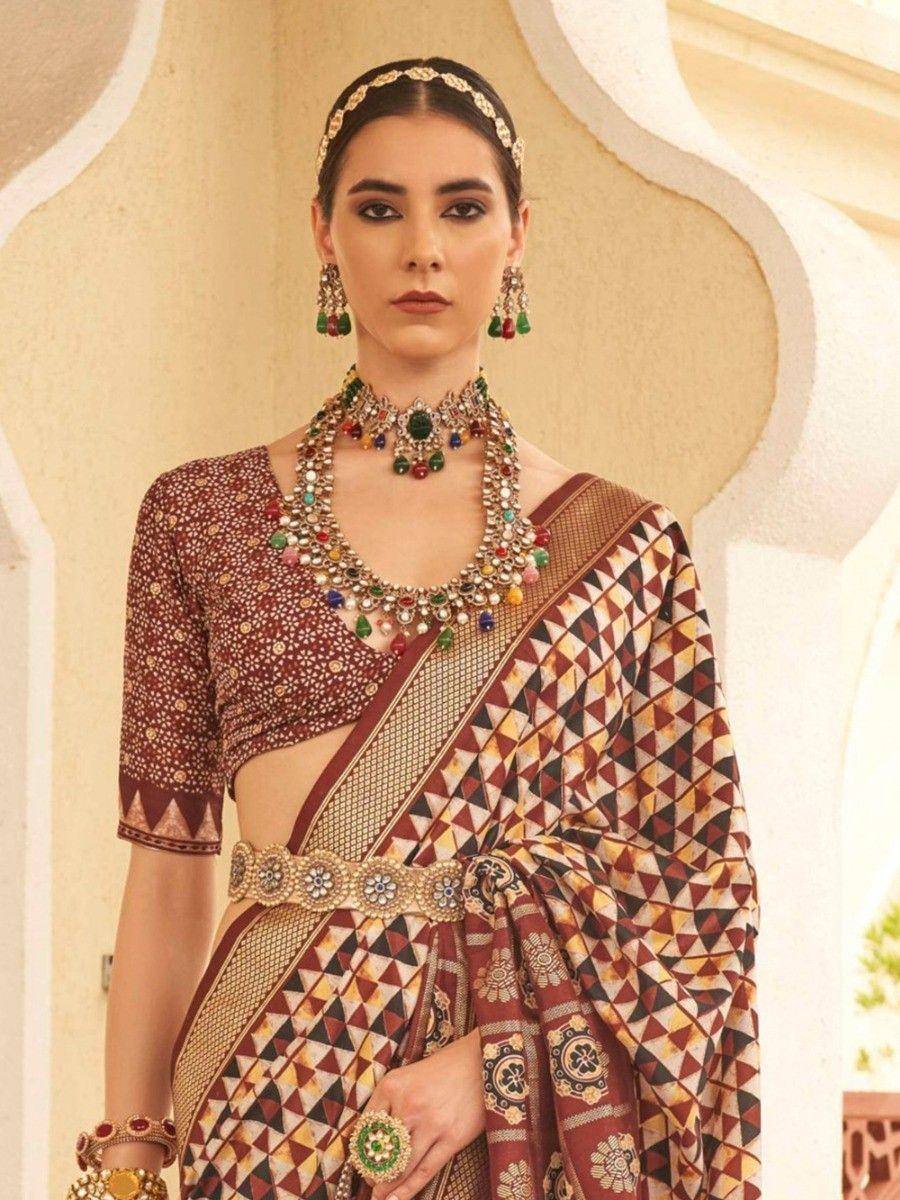 Elegant Indian saree with geometric print, paired with designer blouse and traditional jewelry for festive occasions