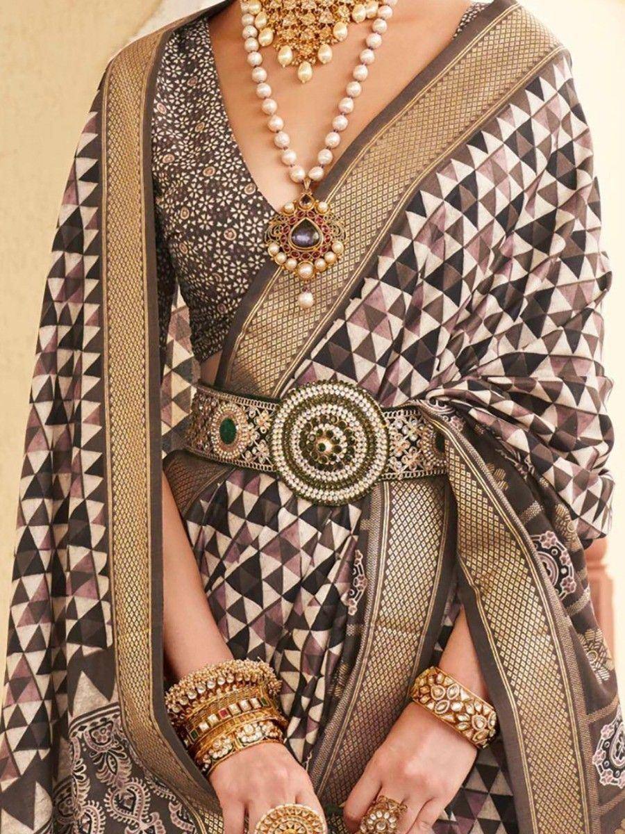 Geometric print saree with gold border, pearl necklace, and ornate belt for Indian ethnic wear