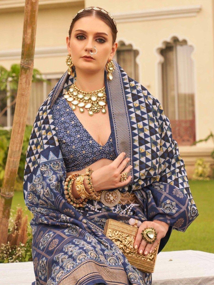 Blue printed ethnic saree with gold jewelry, perfect for Indian weddings or festive occasions