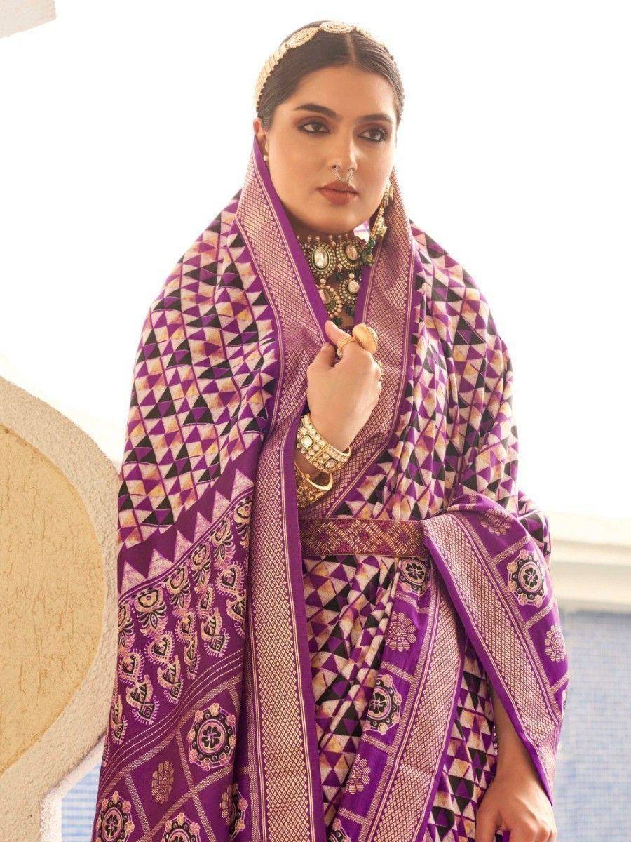 Purple geometric print ethnic saree with gold jewelry, styled for festive occasions