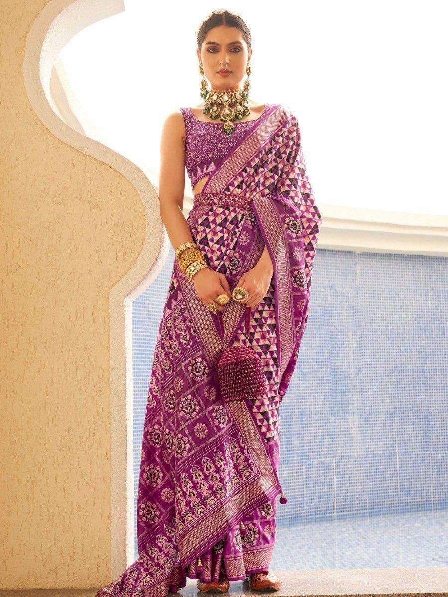 Purple ethnic saree with geometric print, paired with statement jewelry and blouse, perfect for Indian occasions