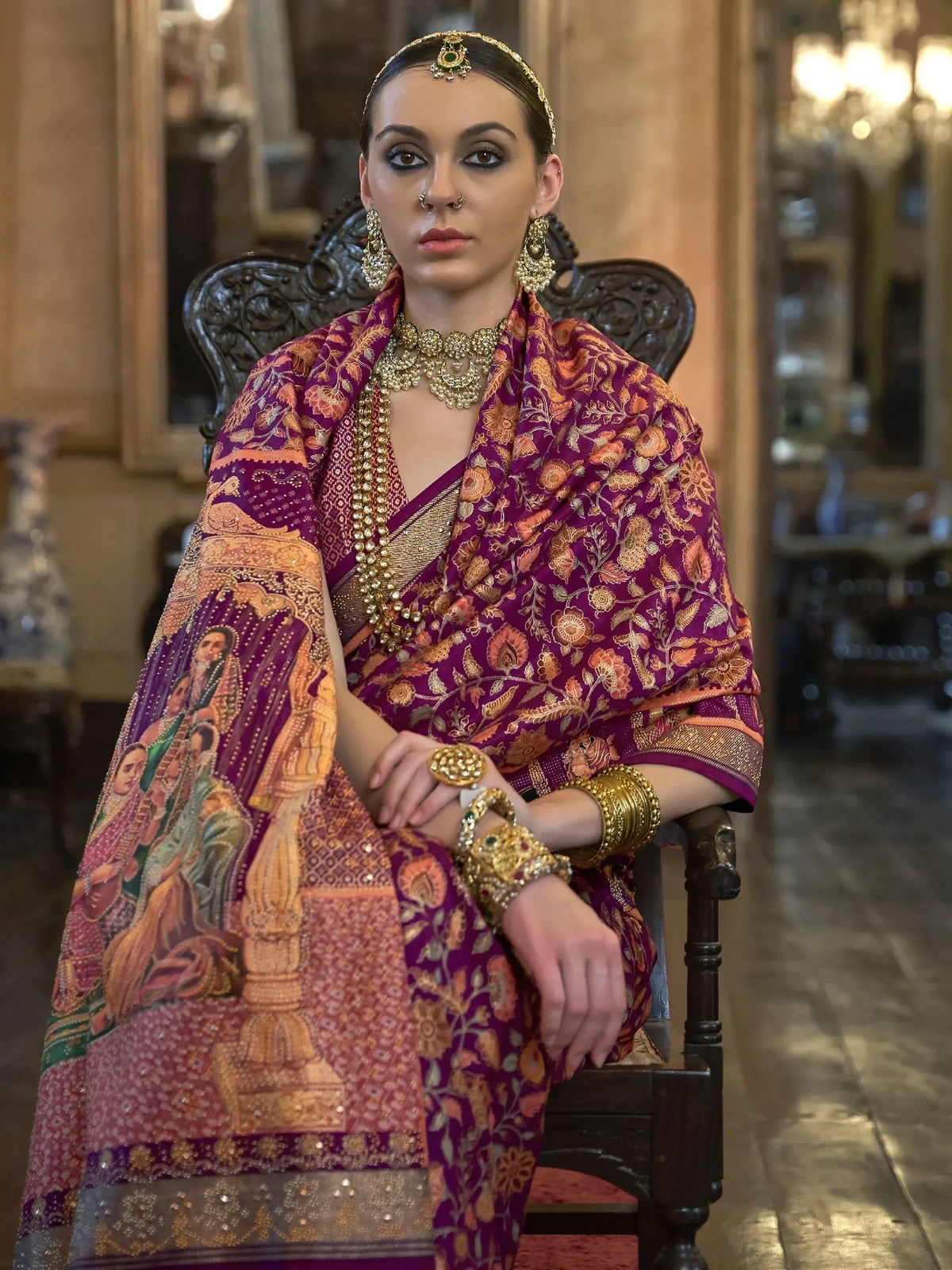 Woman in purple floral saree with gold jewelry, traditional Indian ethnic wear
