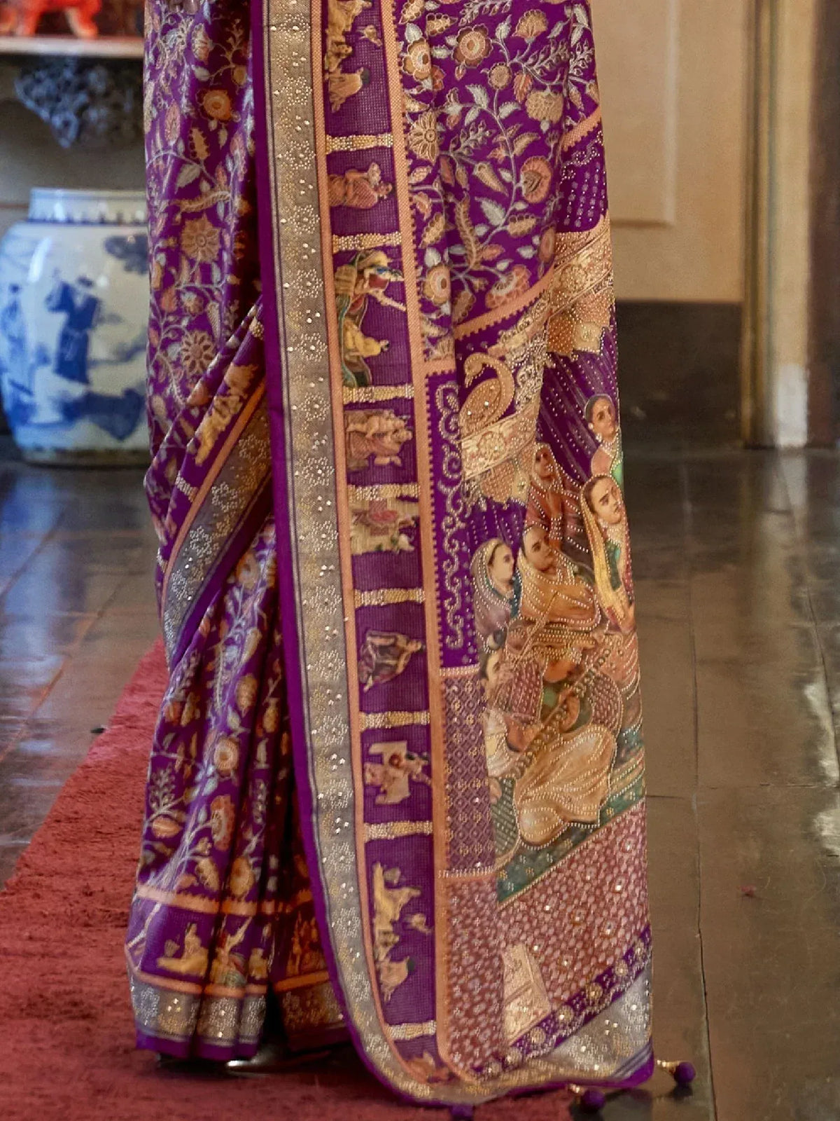 Purple designer saree with intricate floral and figurative embroidery, perfect for ethnic occasions.