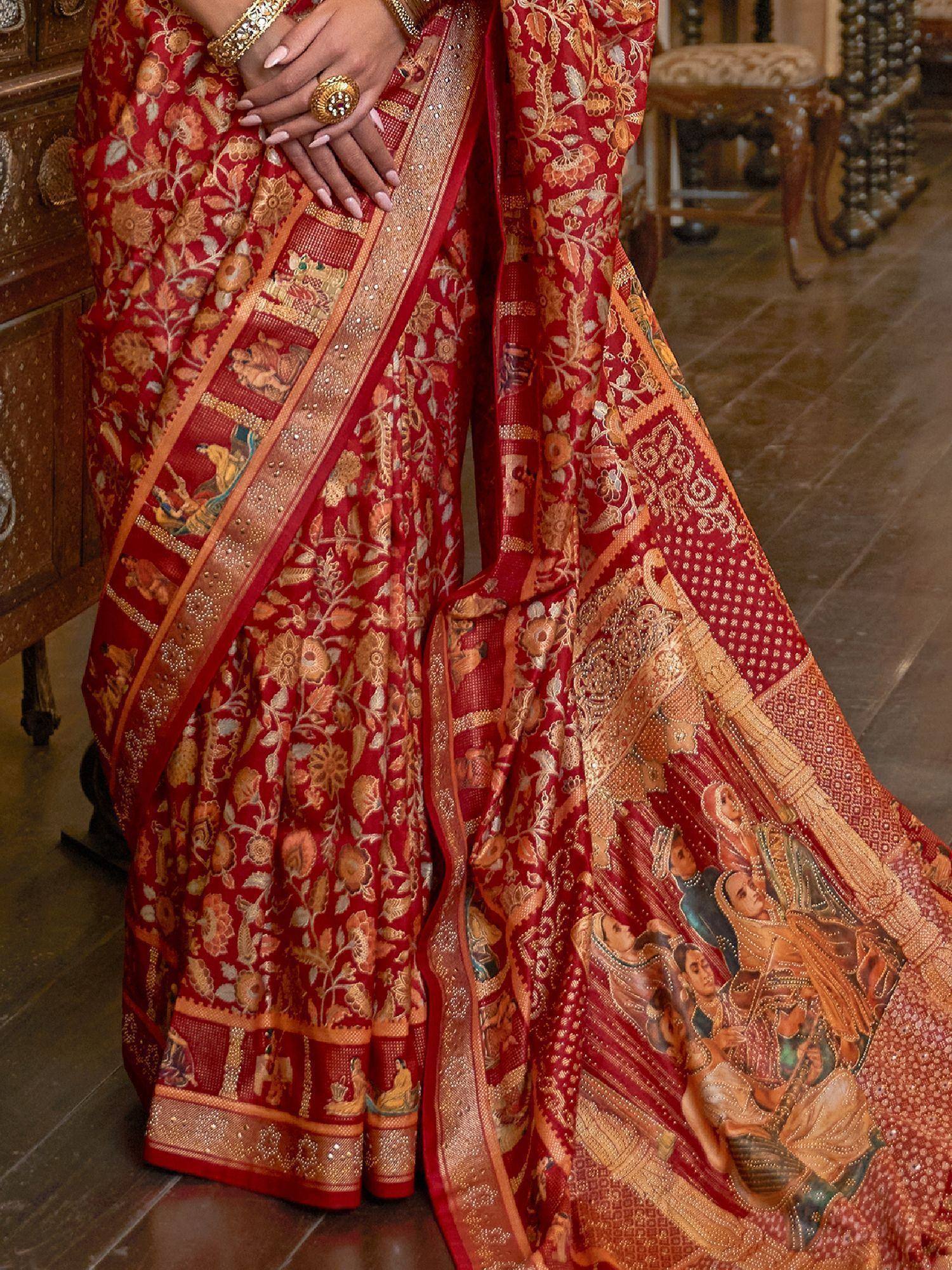 Rich red Indian saree with intricate gold floral and royal scene embroidery, perfect for ethnic occasions.