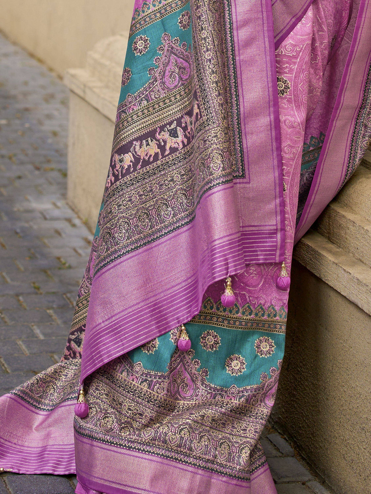 Purple and teal designer saree with intricate paisley, elephant motifs, and tassels, perfect for ethnic wear.