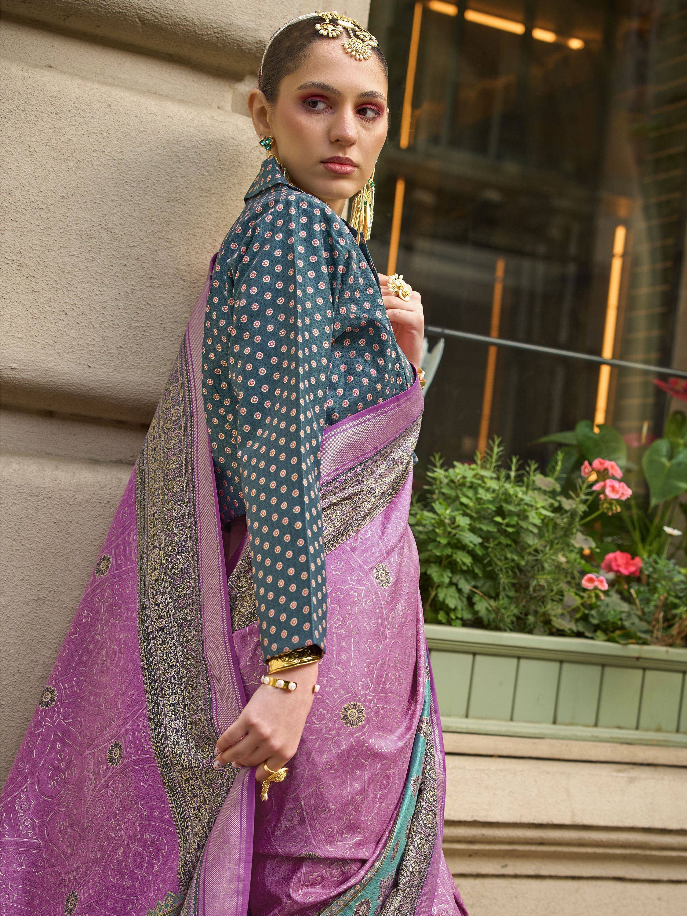 Woman in purple and teal printed saree with gold jewelry, ethnic Indian wear