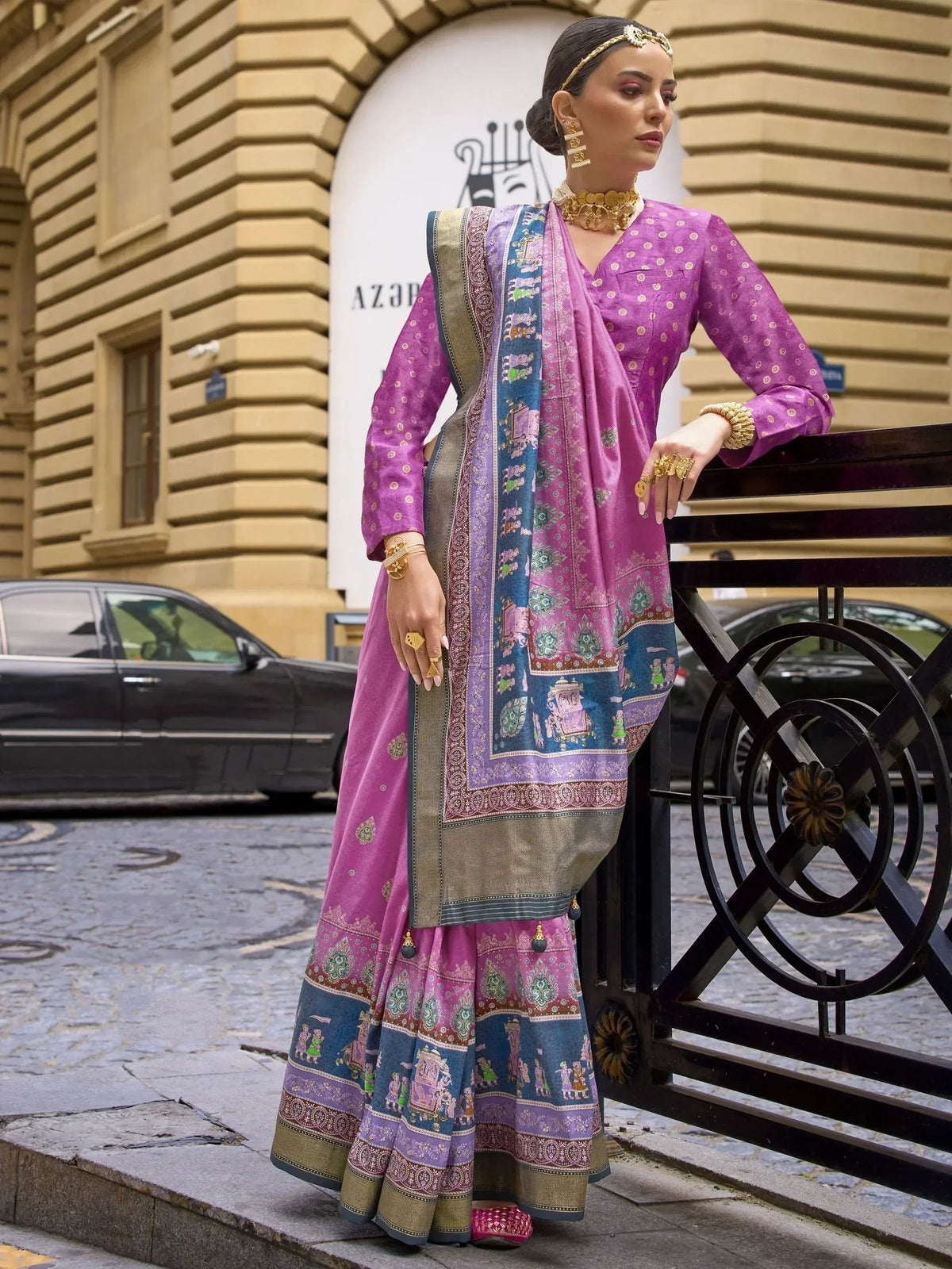 Purple printed ethnic sharara suit with gold jewelry, perfect for Indian festive occasions