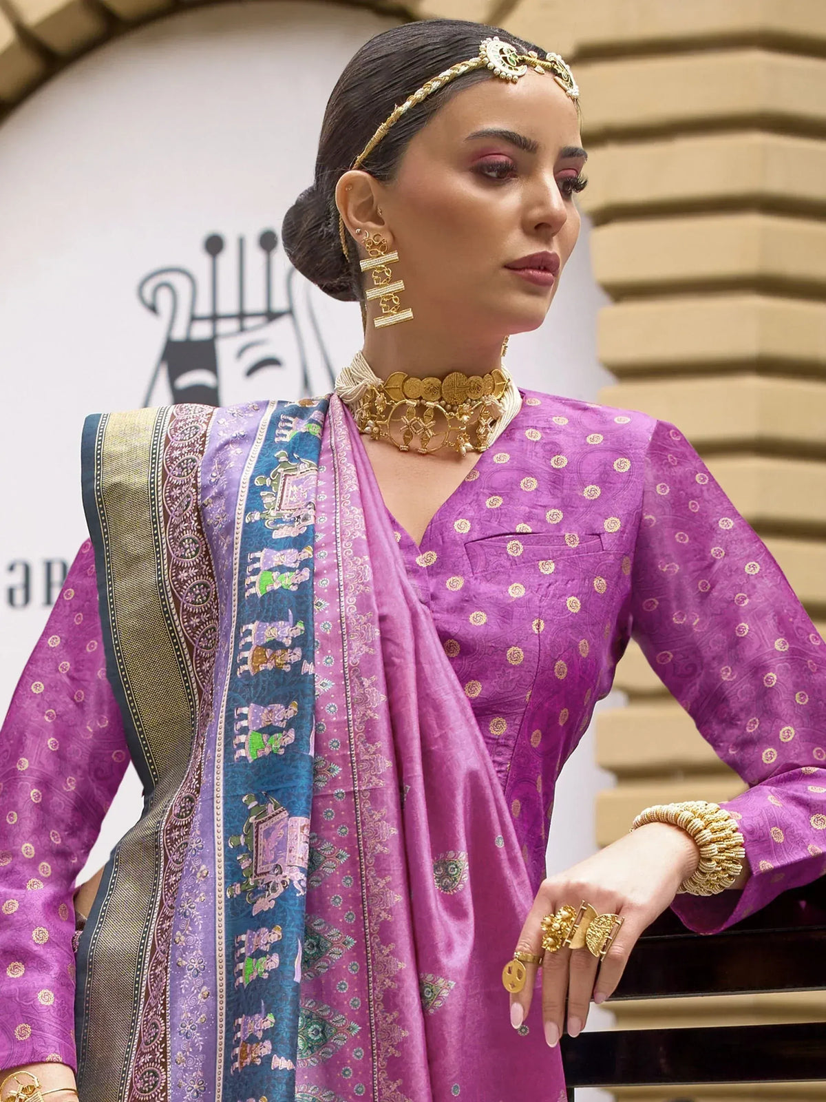 Purple ethnic kurti with gold motifs, printed dupatta, and traditional gold jewelry for Indian wear