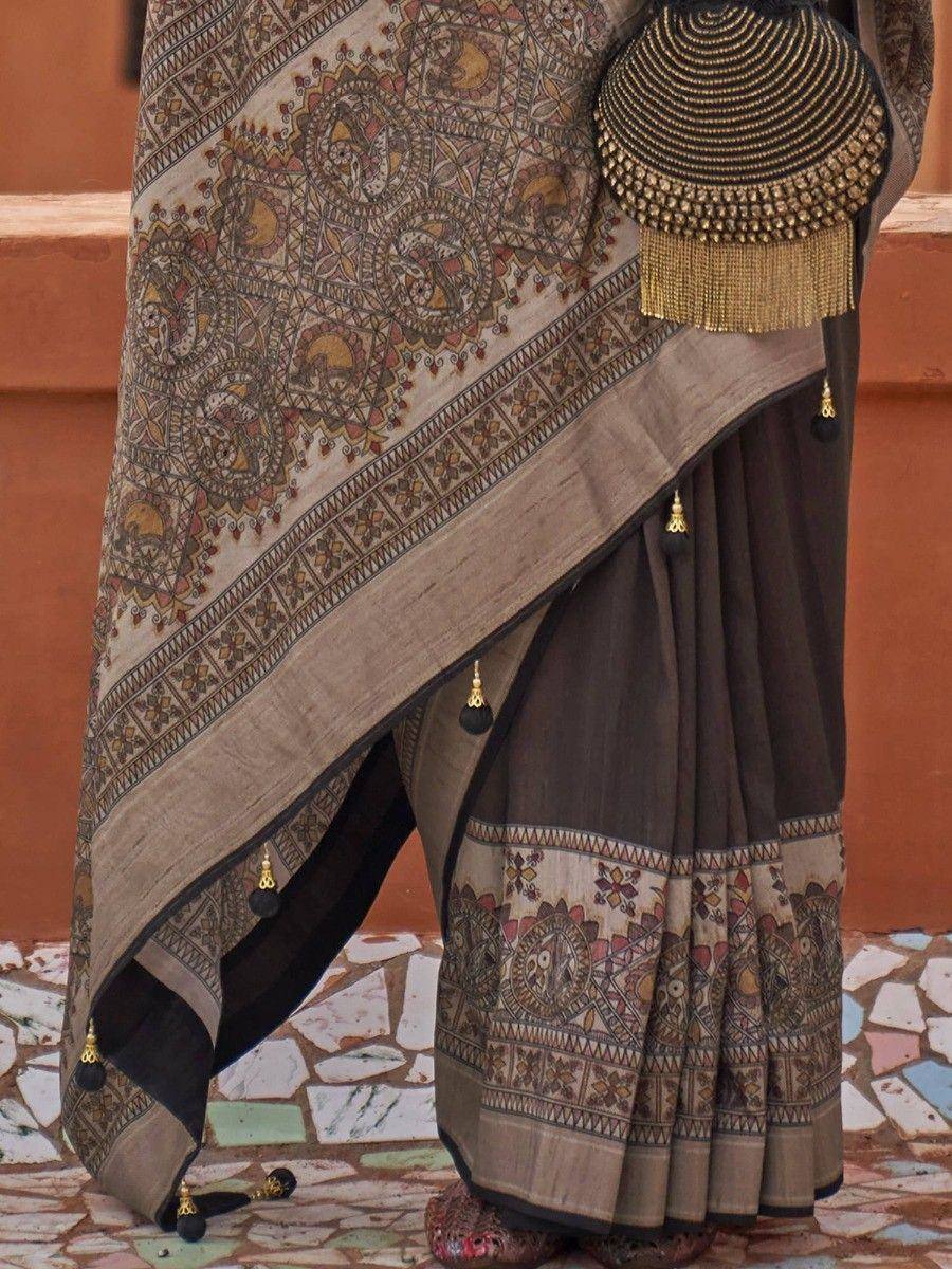 Elegant Indian saree with intricate paisley print, gold tassels, and traditional blouse, perfect for ethnic occasions.