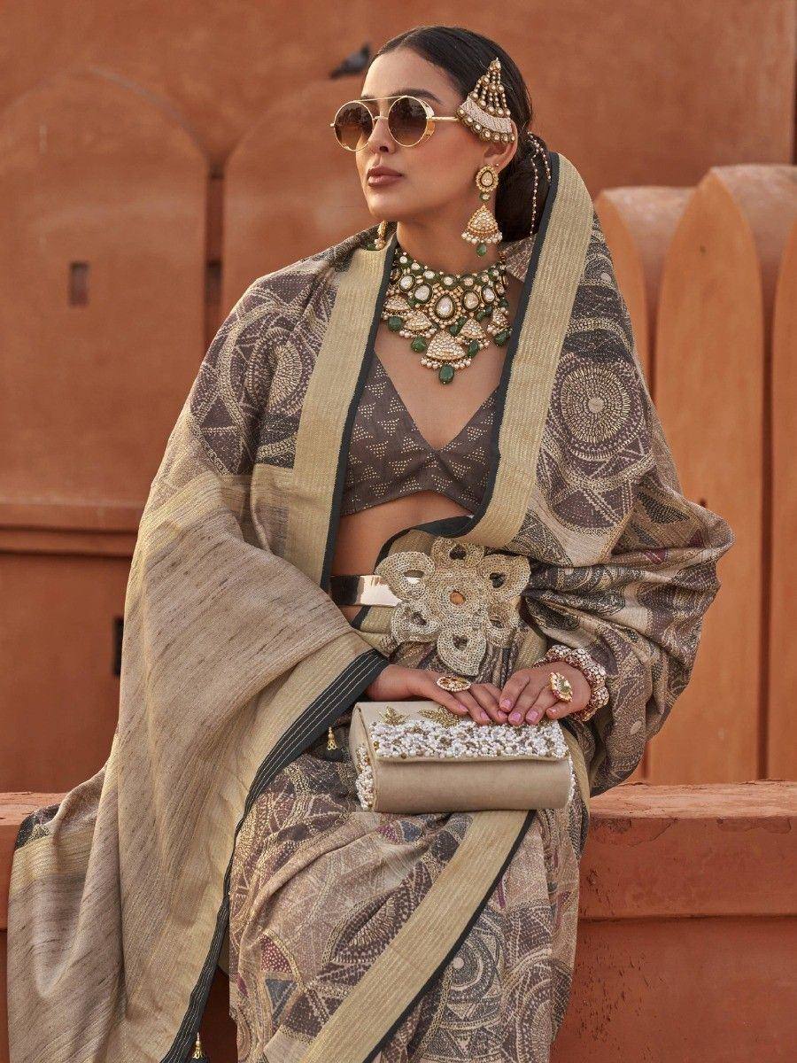 Woman in designer ethnic saree with gold jewelry and sunglasses, styled for festive occasions