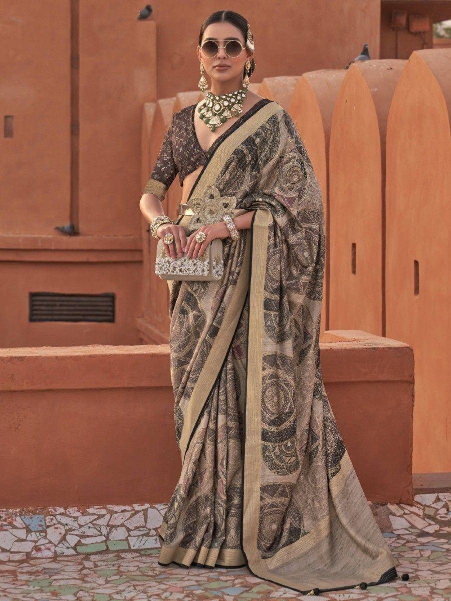 Woman in elegant printed saree with gold border, traditional Indian ethnic wear, styled with statement jewelry