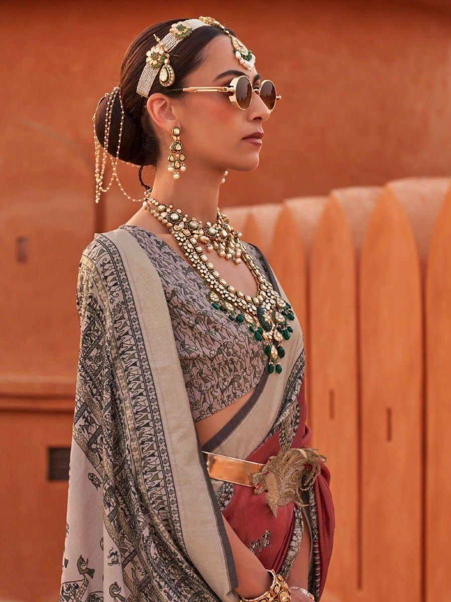 Woman in designer saree with intricate jewelry and sunglasses, ethnic Indian wear