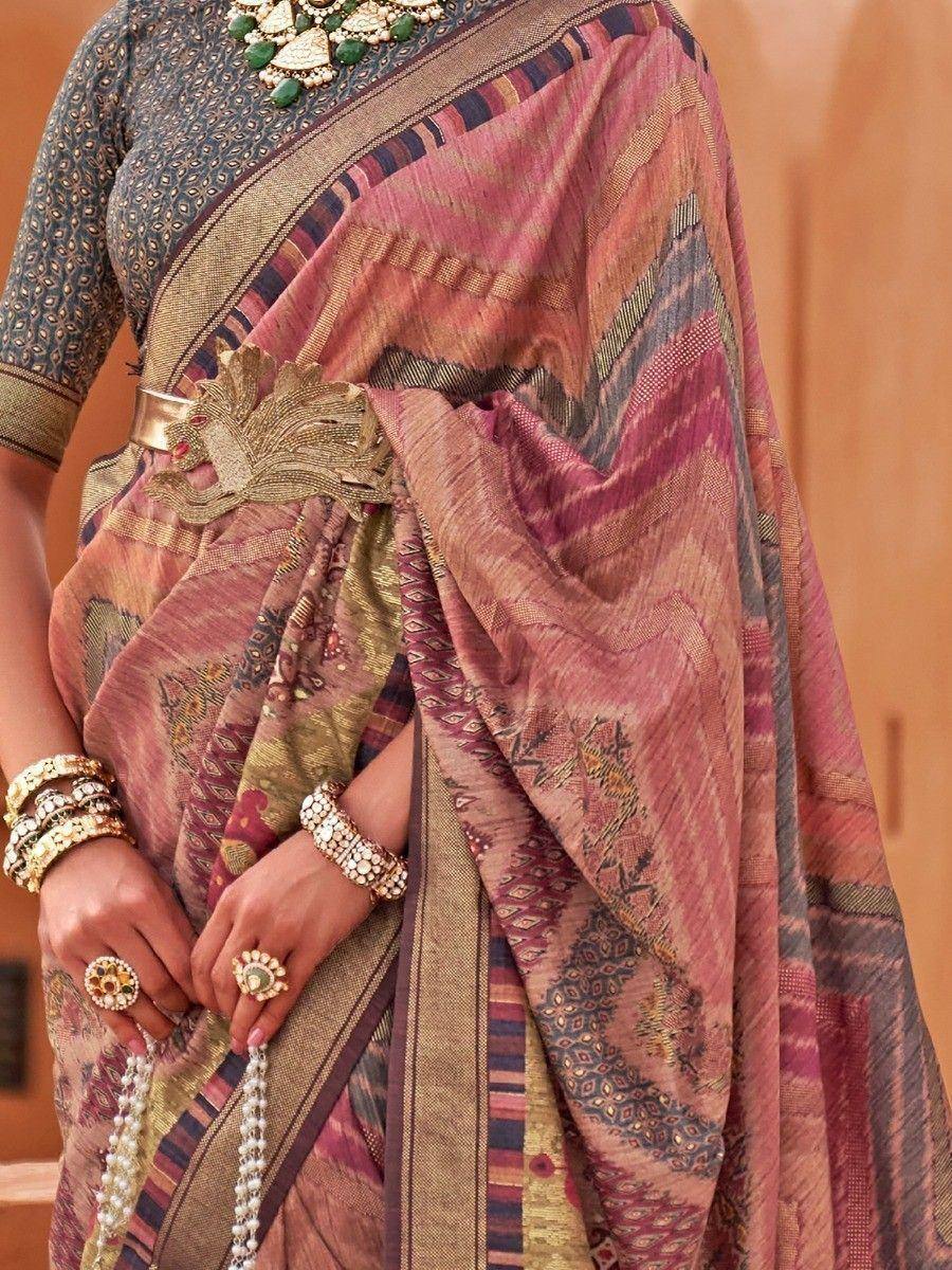 Elegant pink and gold ethnic saree with intricate patterns, paired with traditional jewelry and blouse