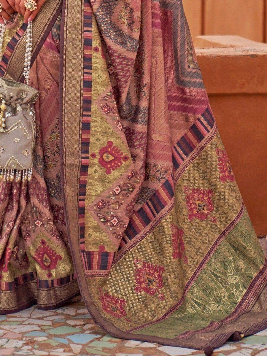 Ethnic Indian saree with intricate paisley and geometric patterns in maroon, gold, and olive green, paired with embellished blouse and potli bag.