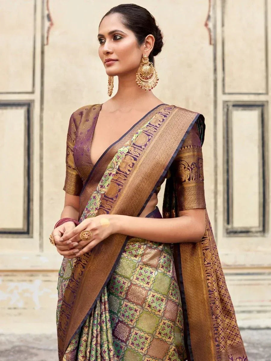 Elegant Indian saree with intricate gold and green patterns, paired with traditional jewelry for ethnic wear.
