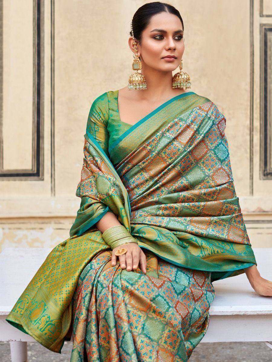 Elegant green and gold patterned saree with traditional Indian design, perfect for ethnic occasions.