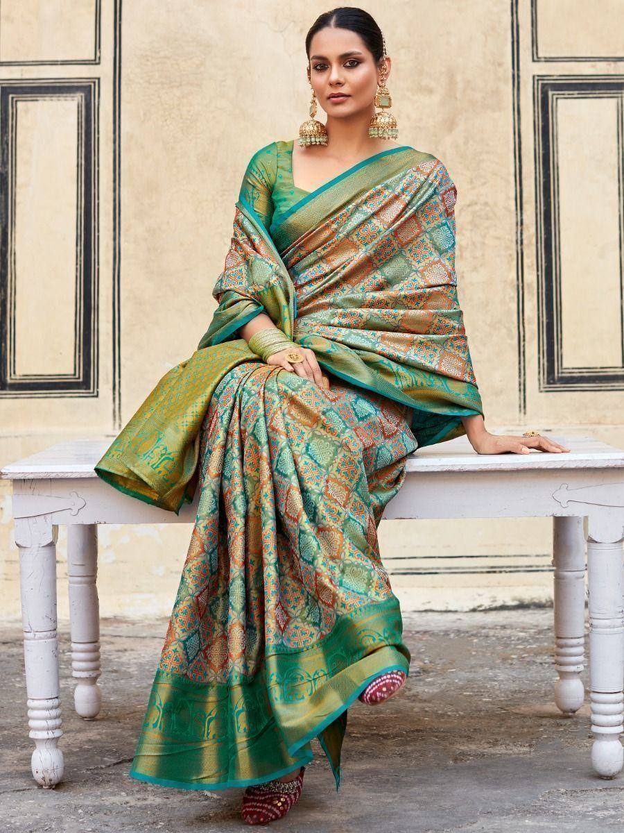 Woman in elegant green and gold printed saree with matching blouse, traditional Indian ethnic wear