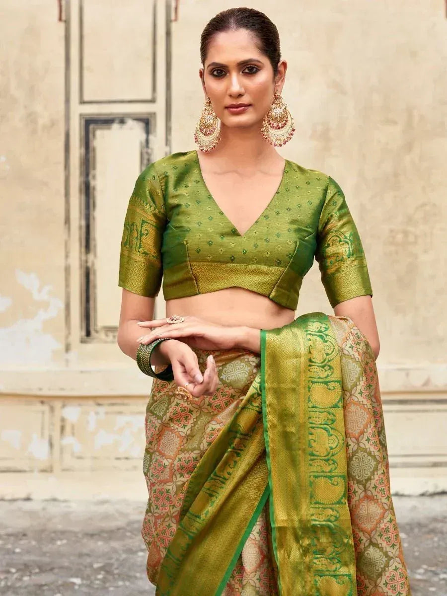 Green designer saree with intricate gold patterns and matching blouse, perfect for ethnic occasions