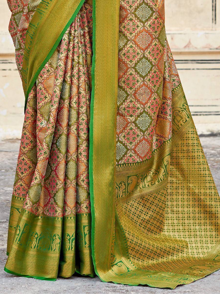 Green and gold designer saree with intricate floral and elephant motifs, perfect for ethnic wear occasions