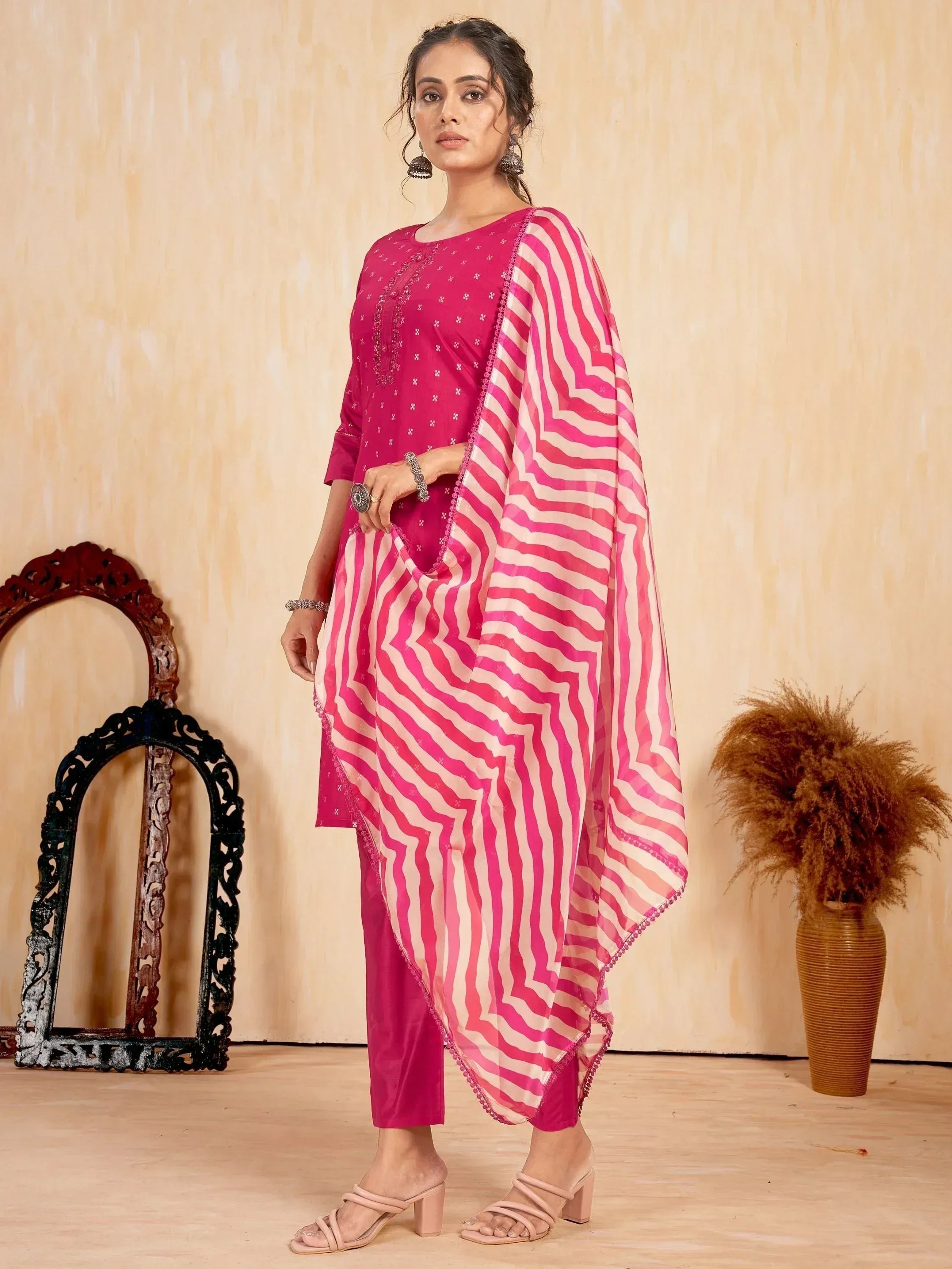 Woman in pink printed ethnic salwar kameez with striped dupatta and block heels