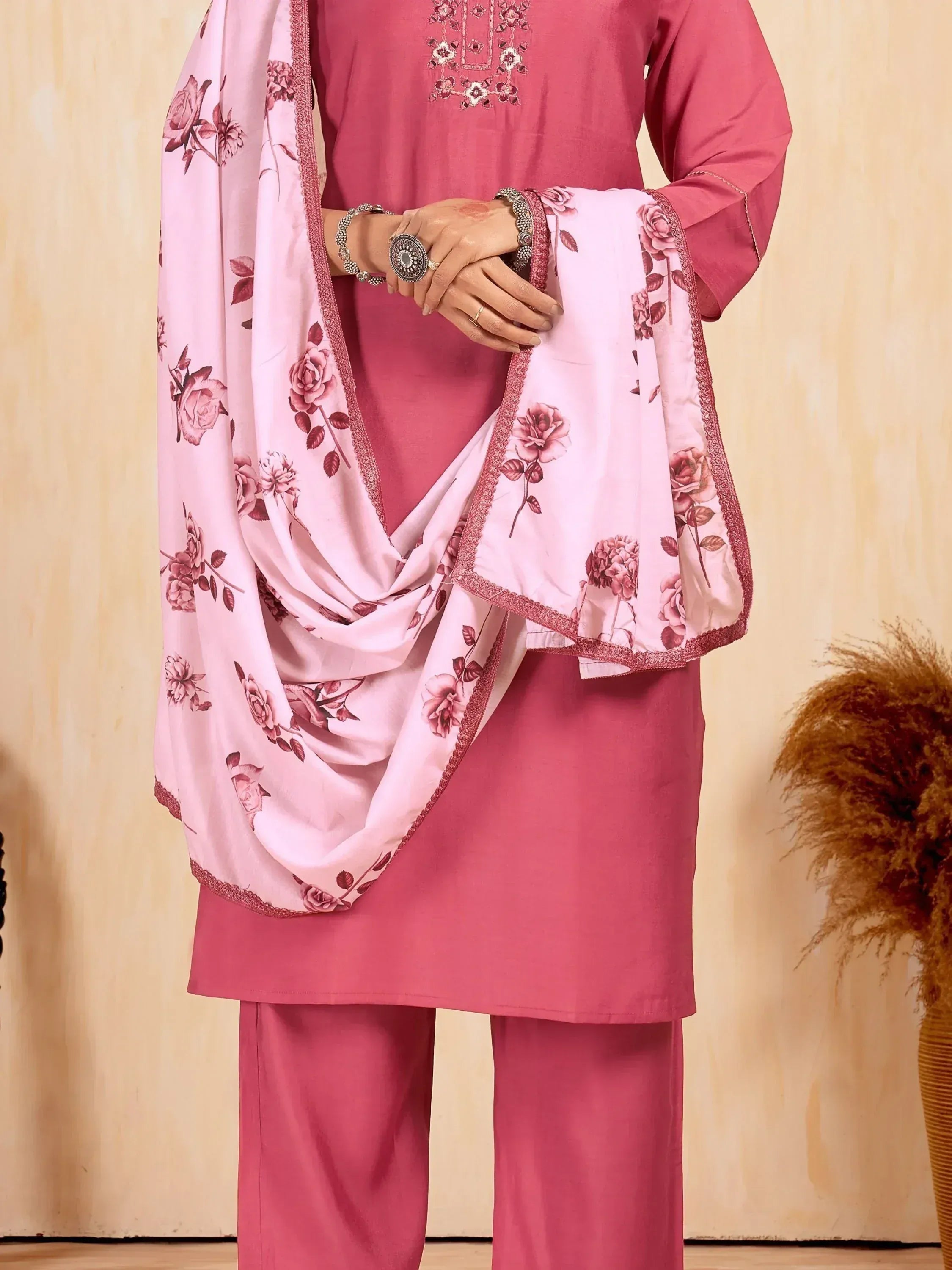 Pink salwar kameez with floral dupatta, embroidered top, and matching pants for ethnic wear