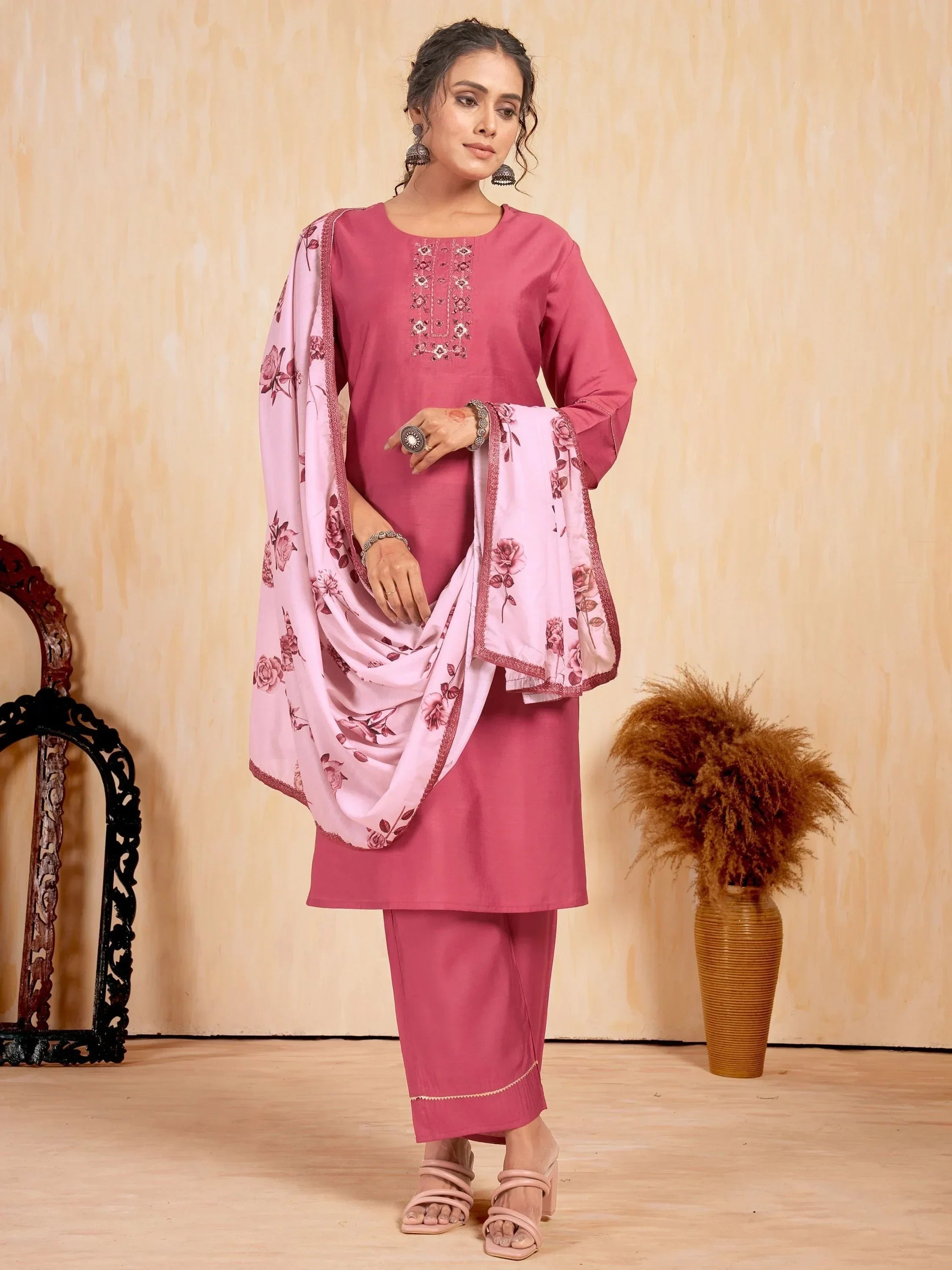 Woman wearing pink embroidered salwar kameez with floral dupatta, ethnic fashion outfit