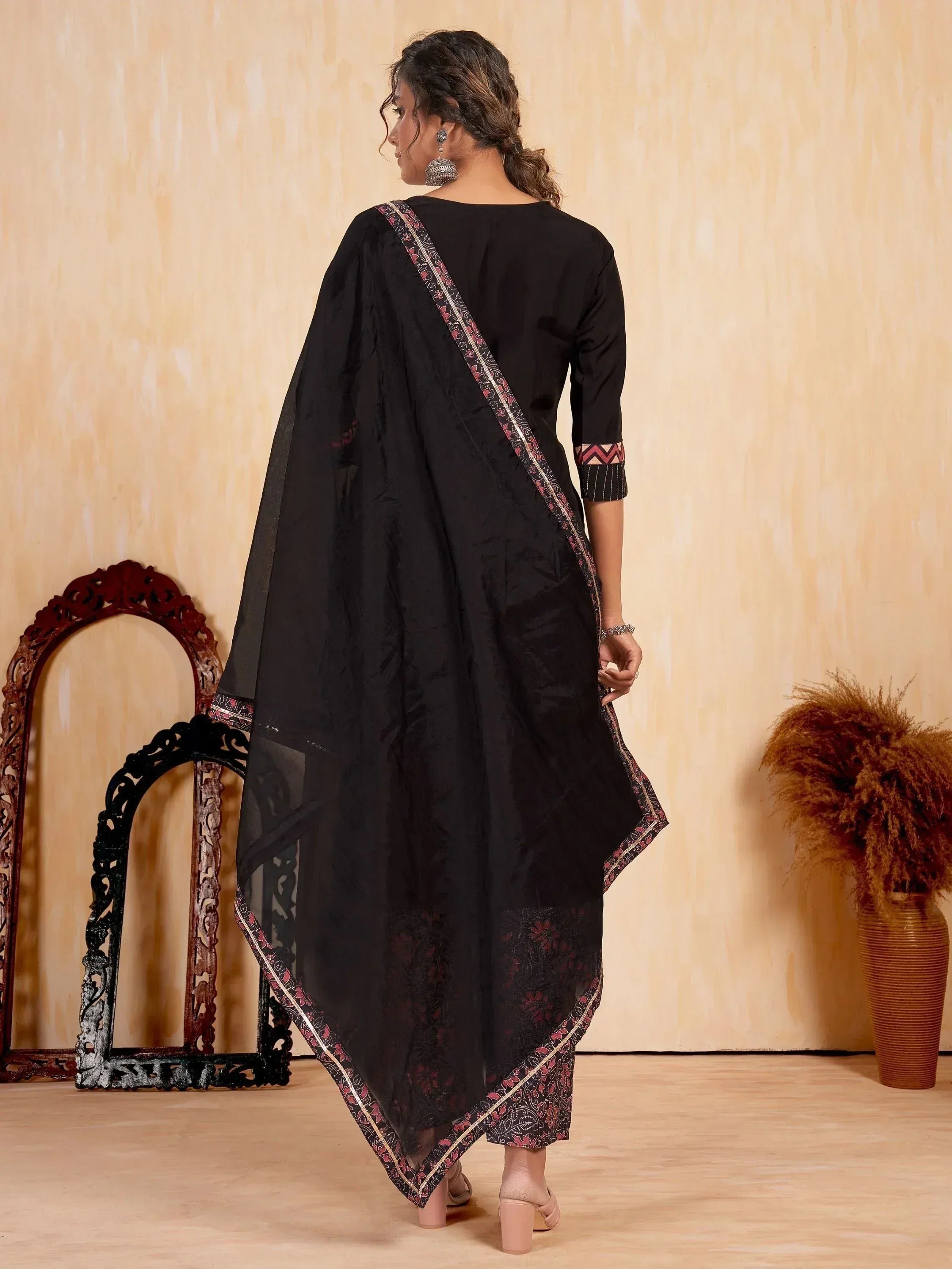 Black ethnic salwar kameez with floral border, perfect for Indian wear and festive occasions