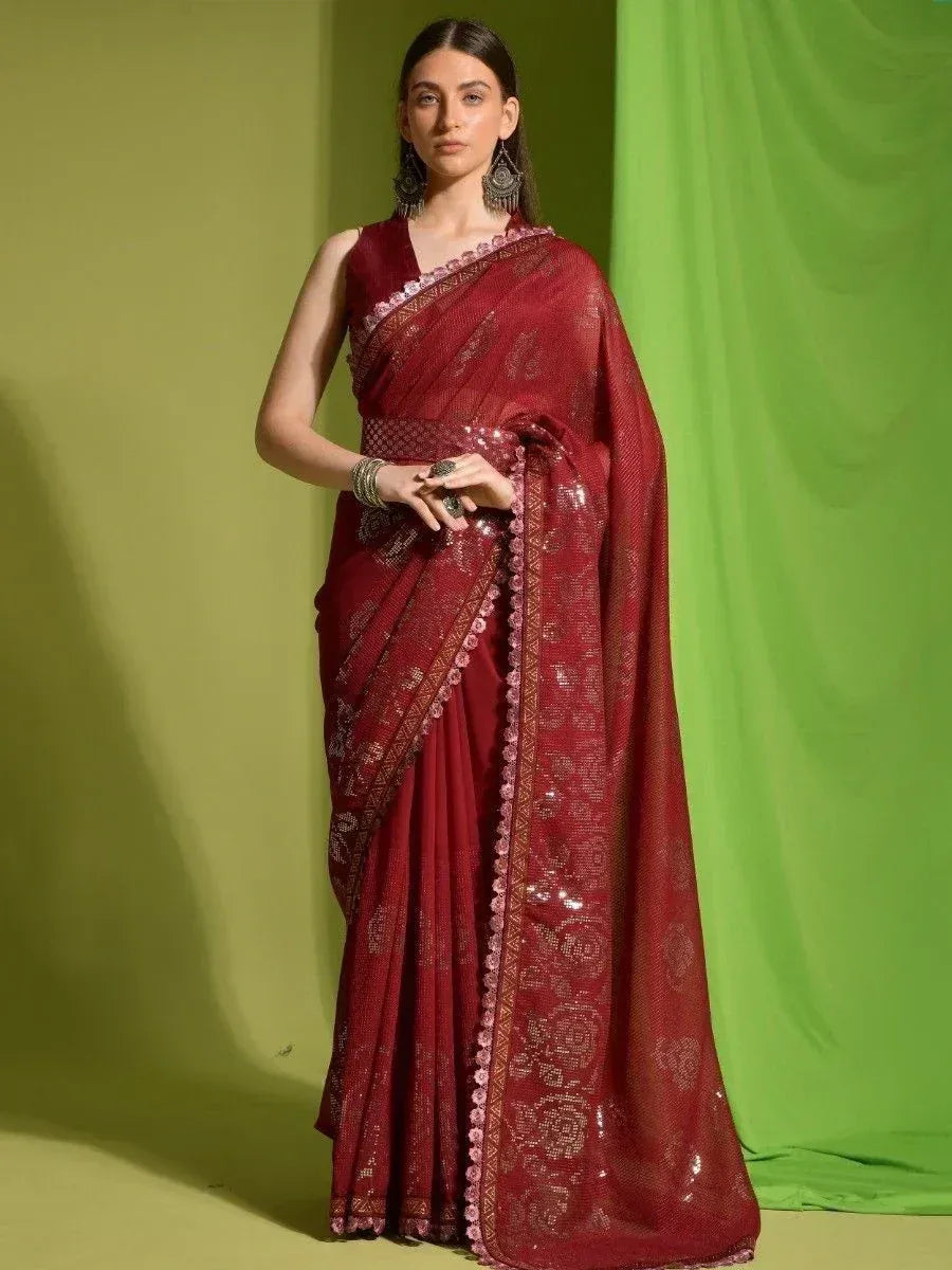 Maroon designer saree with sequin work and pink border, styled with statement earrings for ethnic occasions