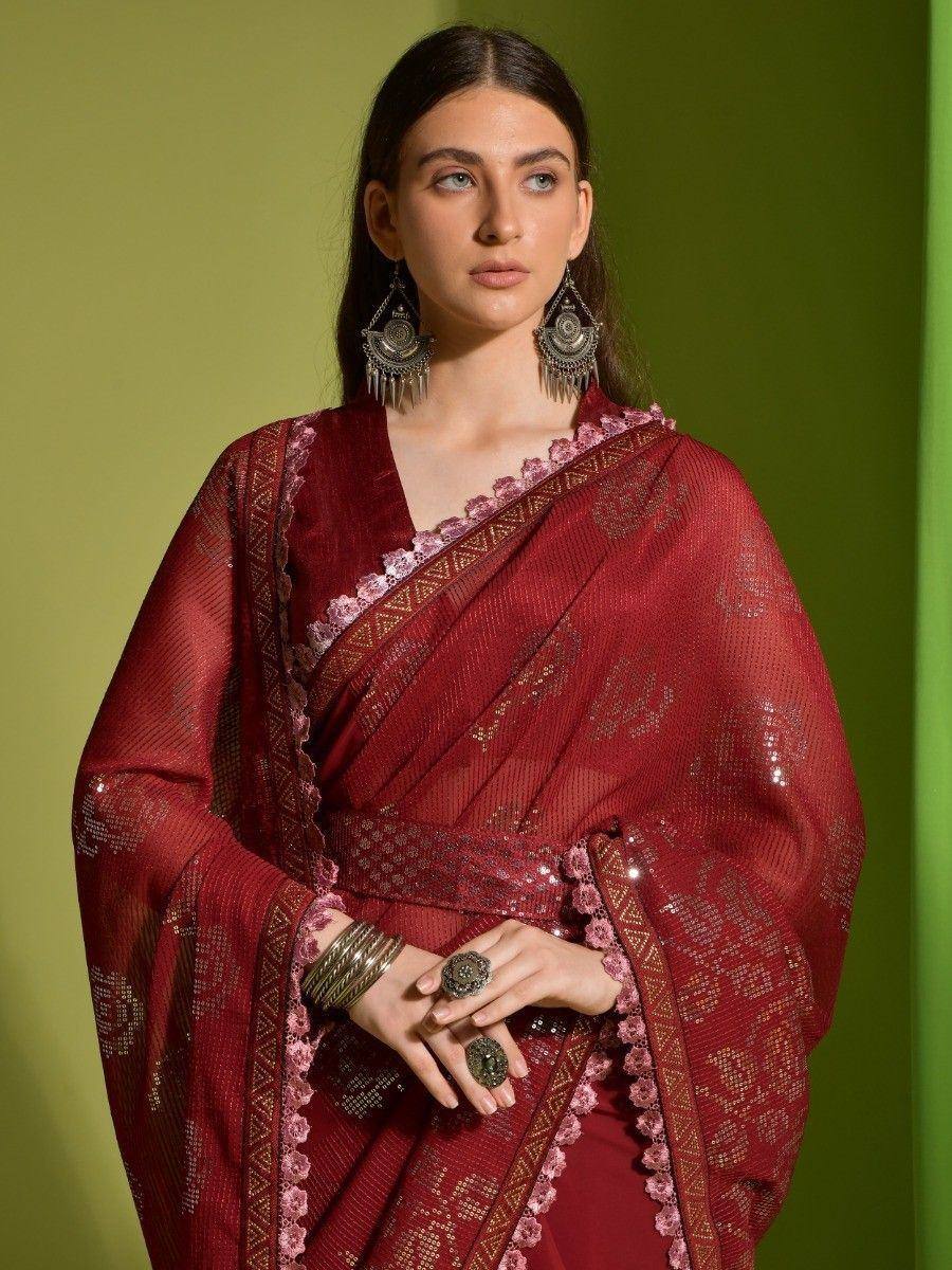 Elegant maroon saree with gold embroidery and pink floral border, paired with statement earrings for ethnic wear