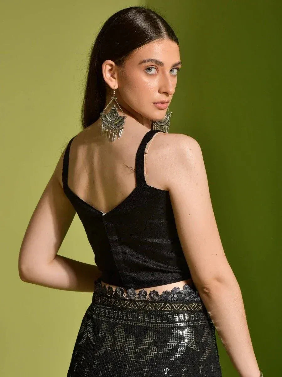 Black velvet crop top with lace trim and sequin skirt, styled with ethnic jhumka earrings for Indian wear