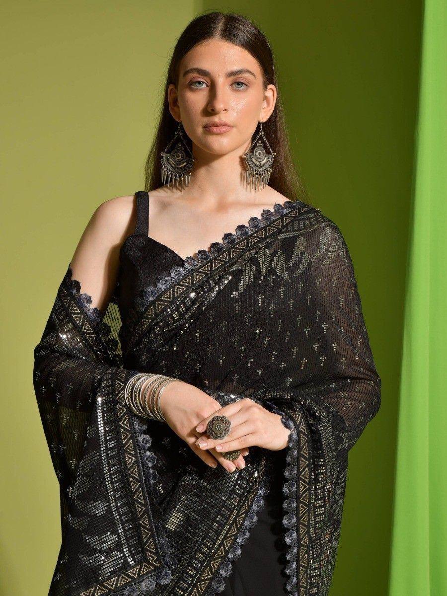 Black embroidered saree with sequins and lace, paired with statement earrings and bangles for ethnic wear