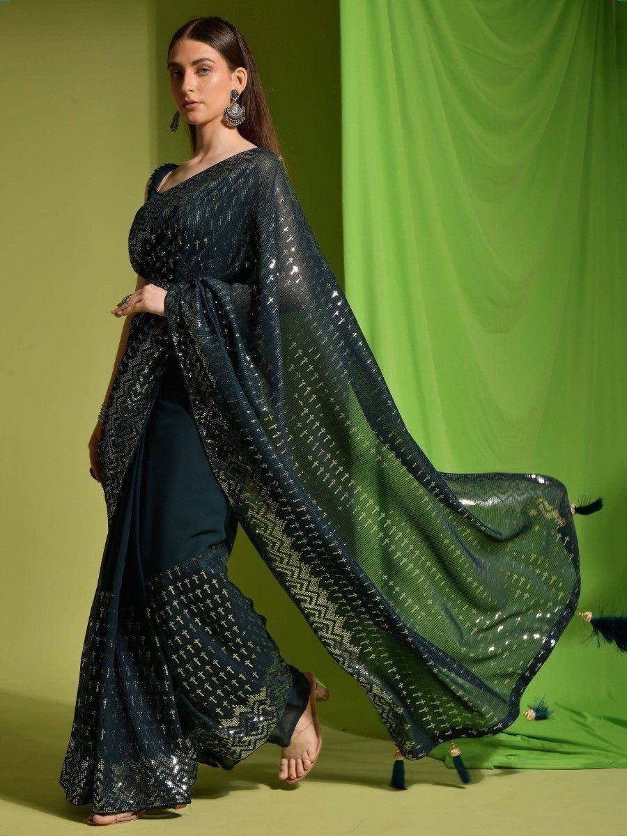 Dark green sequined saree with geometric patterns, elegant drape, and tassel details for Indian ethnic wear