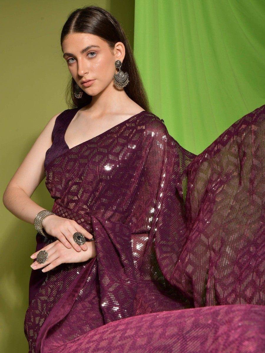 Elegant purple sequin saree with intricate lace detailing, styled with traditional Indian jewelry for festive occasions.