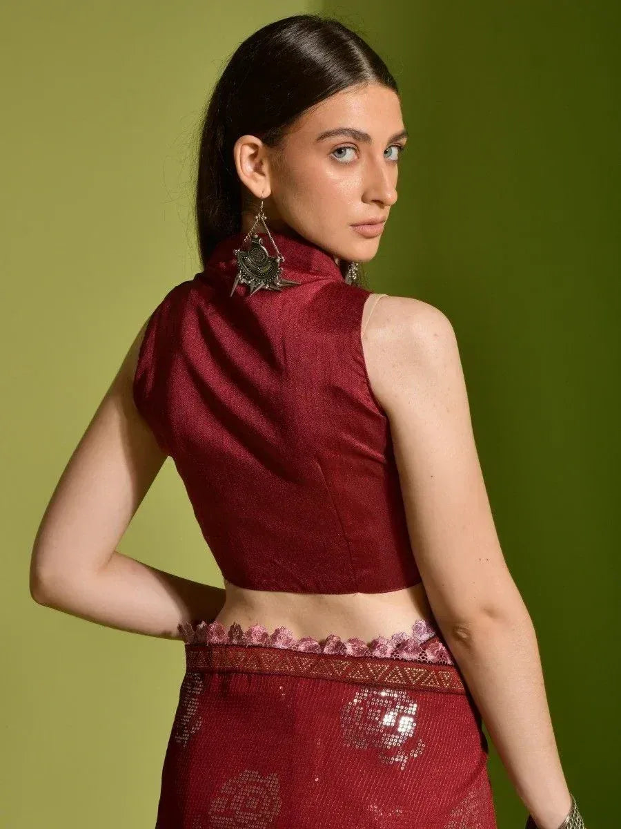 Maroon sleeveless ethnic blouse with high neck, paired with embellished skirt, perfect for Indian festive wear