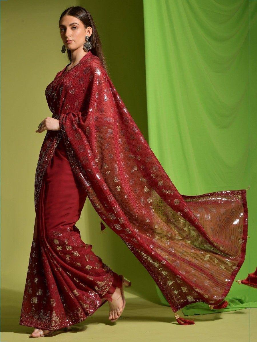 Maroon ethnic saree with gold motifs and sheer dupatta, perfect for Indian weddings or festive occasions