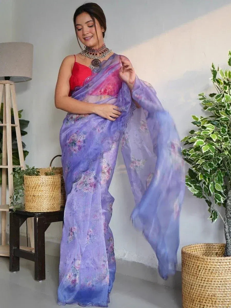 Woman in purple floral saree with red blouse, styled for ethnic occasions