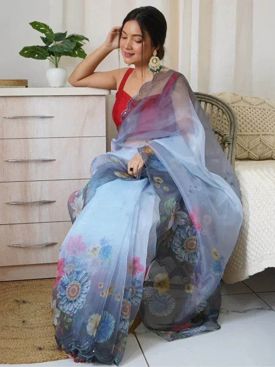 Woman in floral print sheer saree with red blouse, ethnic Indian wear