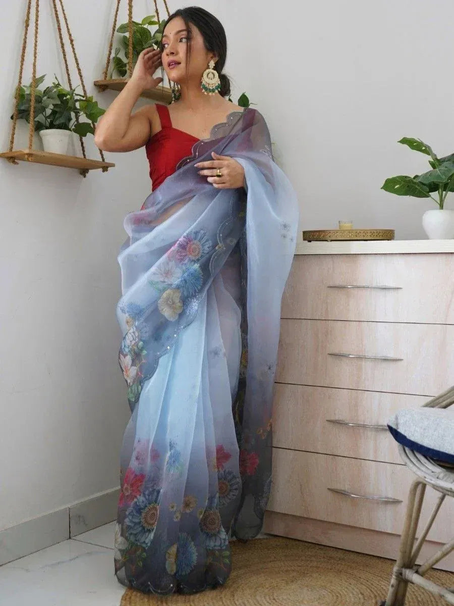 Woman in floral printed sheer saree with red blouse, ethnic Indian wear for festive occasions