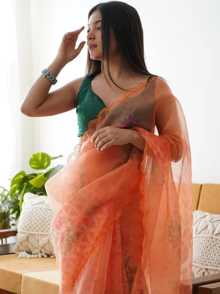 Woman in orange floral saree with green blouse, ethnic Indian wear for festive occasions